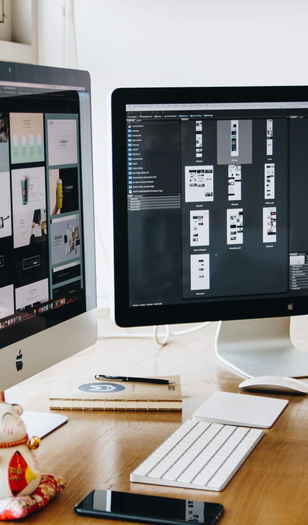 A sleek modern office setup featuring dual monitors, Apple devices, and creative decor in an indoor workspace.