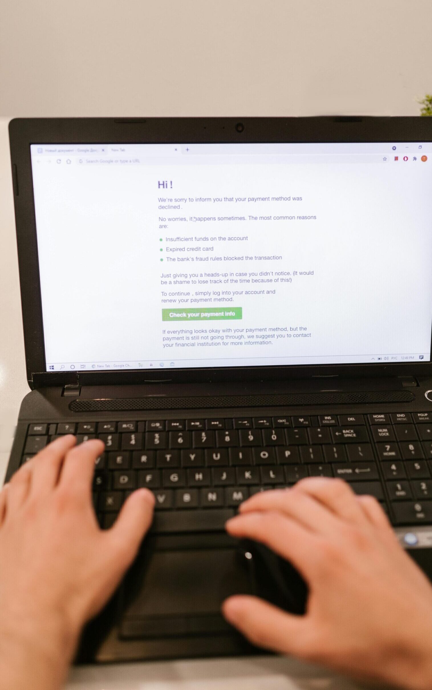 Close-up of hands typing on laptop keyboard, focusing on online payment verification.